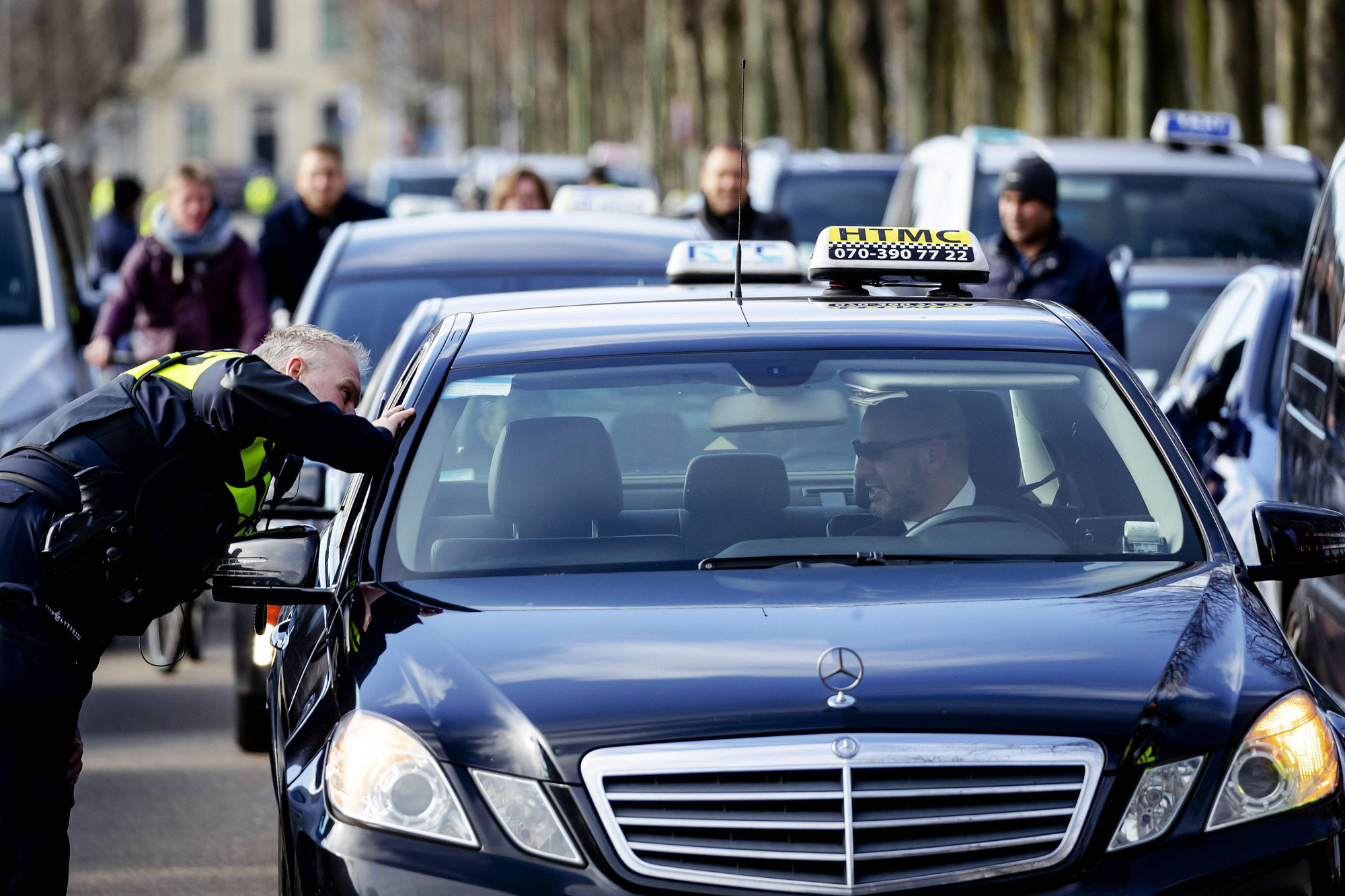 Taxi drivers demonstrate in The Hague, Netherlands, on Tuesday, demanding a ban on Uber. Faced with dramatic changes in how consumers use cars, the automotive industry is engaged in a fierce competition for survival. | AFP-JIJI
