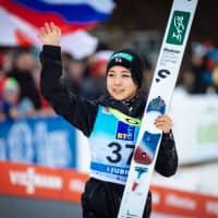 Sara Takanashi celebrates after placing second in the women\'s ski jumping World Cup competition in Ljubno, Slovenia, on Friday. | AFP-JIJI