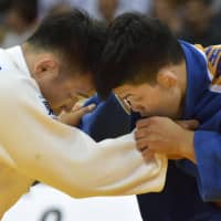 Judoka Masashi Ebinuma (left) and Shohei Ono square off in the men\'s 73-kg division final of the Dusseldorf Grand Slam on Saturday in Dusseldorf, Germany. Ono was the victor, winning one of Japan\'s three gold medals at the event. | KYODO