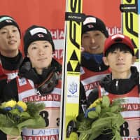 Yukiya Sato (left), Daiki Ito (second from left), Junshiro Kobayashi (second from right) and Ryoyu Kobayashi pose on the podium after taking third place at a ski jumping World Cup team event in Lahti, Finland, on Saturday. | REUTERS