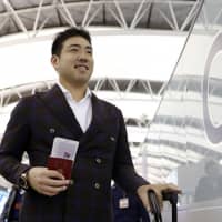 Newly-minted Mariners pitcher Yusei Kikuchi arrives at Kansai International Airport on Sunday ahead of his departure for training camp in the U.S. | KYODO