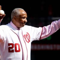 Former Washington Nationals manager Frank Robinson throws out the ceremonial first pitch before Game 3 of the MLB NLDS baseball series between the Washington Nationals and the St. Louis Cardinals in Washington in 2012. | REUTERS