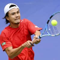 Taro Daniels plays a shot in his singles match against China\'s Zhang Ze in the Davis Cup qualifying round on Friday in Guangzhou, China. Daniels won 7-6 (7-3), 6-4. | KYODO