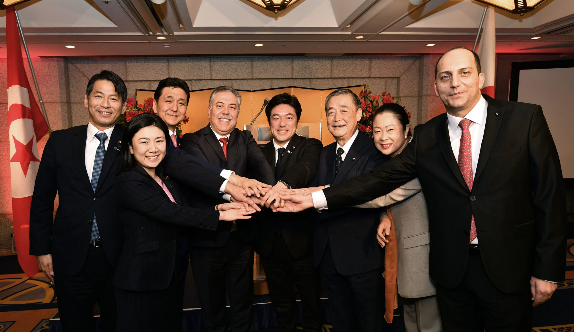 Tunisian Secretary of State for Foreign Affairs Sabri Bachtobji (fourth from left) poses with (from left) Parliamentary Vice-Minister for Foreign Affairs Kenji Yamada; Upper House member Karen Makishima; Japan-Tunisia Parliamentary Committee Chairman Nobuo Kishi; Japan-Tunisia Parliamentary Committee Director General Yasuhide Nakayama; committee members Shinsuke Okuno and Shinako Tsuchiya; and Tunisian Ambassador Mohamed Elloumi during a welcome reception during his official visit to Japan at Hotel Okura Tokyo on Feb. 6. |  YOSHIAKI MIURA