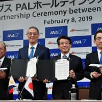Shinya Katanozaka (second from right), ANA Holdings president and CEO, poses with (from left) Philippine Airlines President and COO Jaime J. Bautista; LT Group President and PAL Holdings Director Michael G. Tan; and All Nippon Airways President and CEO Yuji Hirako during a ceremony announcing a business and capital partnership between ANA Holdings and PAL Holdings at the ANA Intercontinental Hotel Tokyo on Feb. 8. | YOSHIAKI MIURA