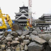 Construction to fix walls surrounding the two towers of Kumamoto Castle, in the city of Kumamoto, continues Tuesday. The castle site, which was damaged in the massive 2016 Kumamoto earthquake, will reopen to tourists in October. | KYODO