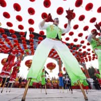 Dancers perform at a traditional Chinese festival at a park in Beijing on Tuesday to celebrate the beginning of the Lunar New Year. | KYODO