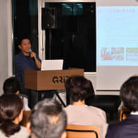 Ashitaka President Naoto Akagi speaks at the seventh Satoyama Cafe on Jan. 15 in Tokyo. | YOSHIAKI MIURA