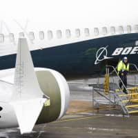 A man works next to a Boeing 737 MAX 9 on the tarmac at the Boeing Renton Factory in Renton, Washington, March 12. U.S. Transportation Secretary Elaine Chao on Tuesday formally directed an internal watchdog  to audit the certification process for Boeing\'s 737 MAX 8 aircraft following recent deadly crashes. Chao\'s request comes amid reports U.S. authorities have also launched a criminal probe into the certification of the top-selling jet. | AFP-JIJI