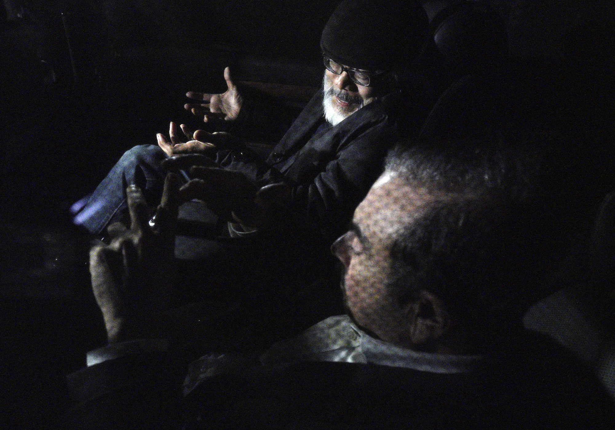 Former Nissan Motor Co. Chairman Carlos Ghosn (front) and his lawyer Takashi Takano chat in a car after Ghosn was released on bail from Tokyo Detention House on Wednesday. | AP