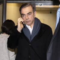 Carlos Ghosn, former chairman of Nissan Motor Co., leaves the office of his lawyer in Tokyo on March 12. | BLOOMBERG