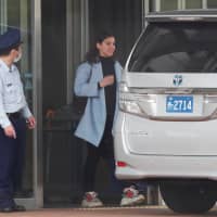 Caroline Ghosn, daughter of ousted Nissan Motor Co. chief Carlos Ghosn, leaves the Tokyo Detention House, where her father was being detained, on Wednesday. | REUTERS