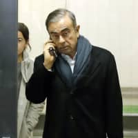 Former Nissan Motor Co. Chairman Carlos Ghosn, facing financial misconduct charges and released on bail, leaves his lawyer\'s office in Tokyo on March 12. | KYODO