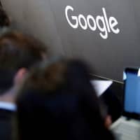 Journalists follow a news conference during the opening of the new Alphabet\'s Google Berlin office in Berlin in January. | REUTERS