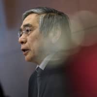 Gov. Haruhiko Kuroda holds a news conference Friday at the Bank of Japan. | BLOOMBERG