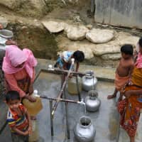 Rohingya refugees collect drinking water at the Shalbagan refugee camp in Teknaf, Bangladesh, Tuesday. | REUTERS