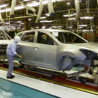 Increased production of cars and auto parts contributed to a rise in industrial output in February, the first gain in four months. | KYODO
