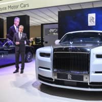 Torsten Muller-Otvos, chief executive officer of Rolls-Royce Motor Cars Ltd., gestures while speaking near a Rolls-Royce Motor Cars Ltd. Phantom automobile on the opening day of the 89th Geneva International Motor Show in Geneva on Tuesday. The show near Lake Leman, which opens to the public from Thursday to March 17, will be the first gilded showcase of the year for the likes of Bugatti, Koenigsegg, Lamborghini, and Pininfarina, among others. | BLOOMBERG