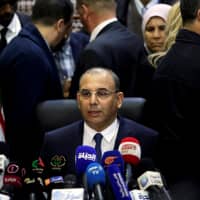 Abdelghani Zaalane, campaign manager of President Abdelaziz Bouteflika, speaks after he submitted Bouteflika\'s official election papers at the Constitutional Council in Algiers Sunday. | REUTERS