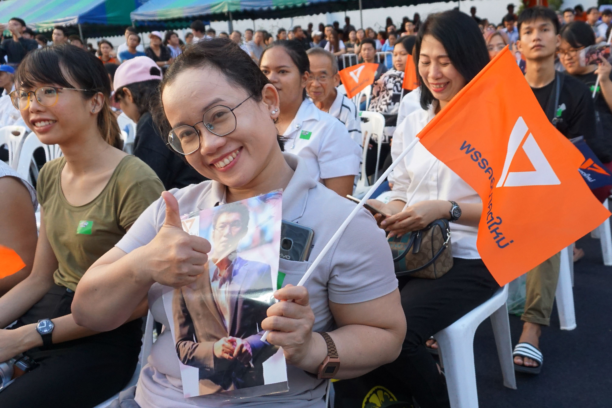 Supporters of Future Forward Party leader Thanathorn Juangroongruangkit attend a televised live debate for candidates in Bangkok on Wednesday. | AFP-JIJI