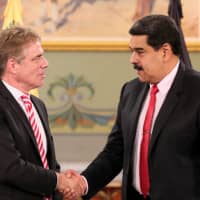 Venezuelan President Nicolas Maduro (right) greets Germany\'s new ambassador to Venezuela, Daniel Martin Kriener, after receiving his diplomatic credentials during a ceremony at Miraflores Palace in Caracas in September. | MIRAFLORES PALACE / HANDOUT / VIA REUTERS