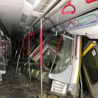 A damaged Mass Transit Railway train is seen following a collision near Hong Kong\'s Central station during a signal system trial on Monday. | REUTERS