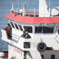 Armed troops are seen aboard the Turkish oil tanker El Hiblu 1, which was hijacked by migrants earlier in the week, in the port at Valletta on Thursday. | AP