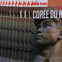 The North Korea Petit Fute guidebook is displayed during an interview in Paris on Tuesday. | REUTERS