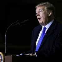 U.S. President Donald Trump addresses members of the military during a refueling stop at Elmendorf Air Force Base in Anchorage, Alaska, Thursday. | REUTERS
