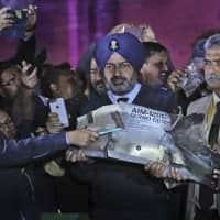 Indian defense officials in New Delhi on Thursday display part of an air-to-air missile that allegedly was fired by a Pakistani Air Force aircraft that violated Indian airspace. | AP