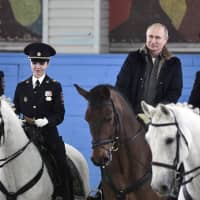 Russian President Vladimir Putin rides a horse on a visit to a mounted police unit in Moscow Thursday. | ALEXEI NIKOLSKY / SPUTNIK / KREMLIN POOL PHOTO / VIA AP