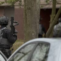 Dutch counterterrorism police prepare to enter a house after a shooting incident in Utrecht, Netherlands, Monday. | AP