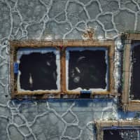 In this aerial view taken in January, captured marine mammals are seen in enclosures at a holding facility in Srednyaya Bay in the Far Eastern town of Nakhodka, Russia. Dozens of orca and beluga whales captured for sale to oceanariums have brought Russia\'s murky trade into the spotlight, but efforts to free them are blocked by government infighting. | AFP-JIJI