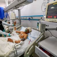 A Yemeni boy lies in a hospital as he receives treatment in the Houthi-rebel-held capital Sanaa on Monday for wounds sustained during a reported airstrike in the Kisar district of the northern Hajjah province. | AFP-JIJI