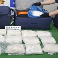 Bags of smuggled stimulant drugs are shown at Narita airport on Monday. | KYODO