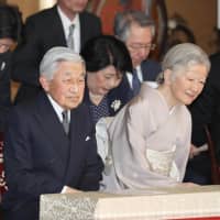Emperor Akihito and Empress Michiko listen to gagaku, Japan\'s ancient court music, at a concert in the Imperial Palace on Monday. | POOL / VIA KYODO