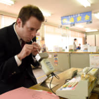 Taxi driver Alex Lipson takes a Breathalyzer test before starting his shift.  | SATOKO KAWASAKI