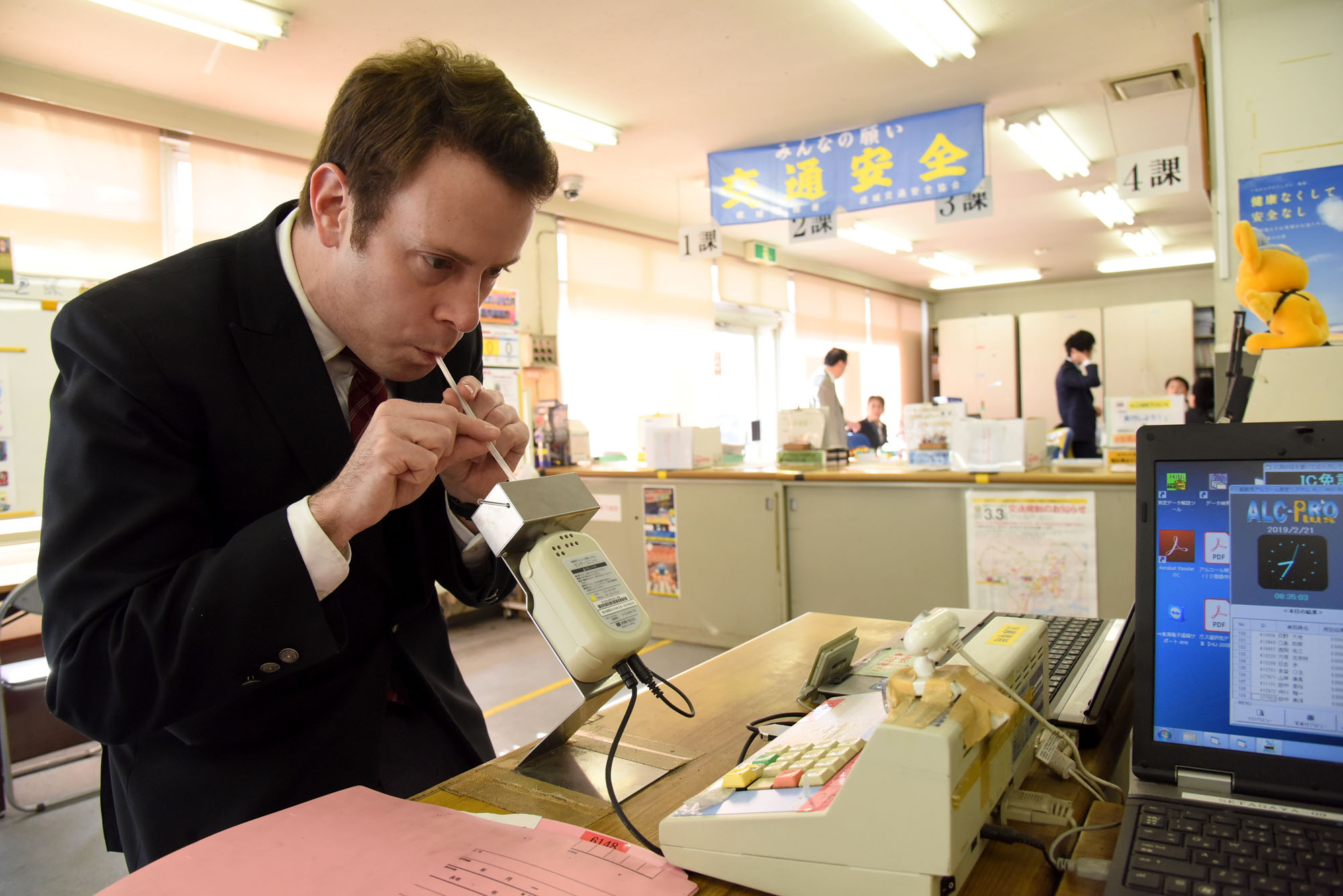 Taxi driver Alex Lipson takes a Breathalyzer test before starting his shift. 