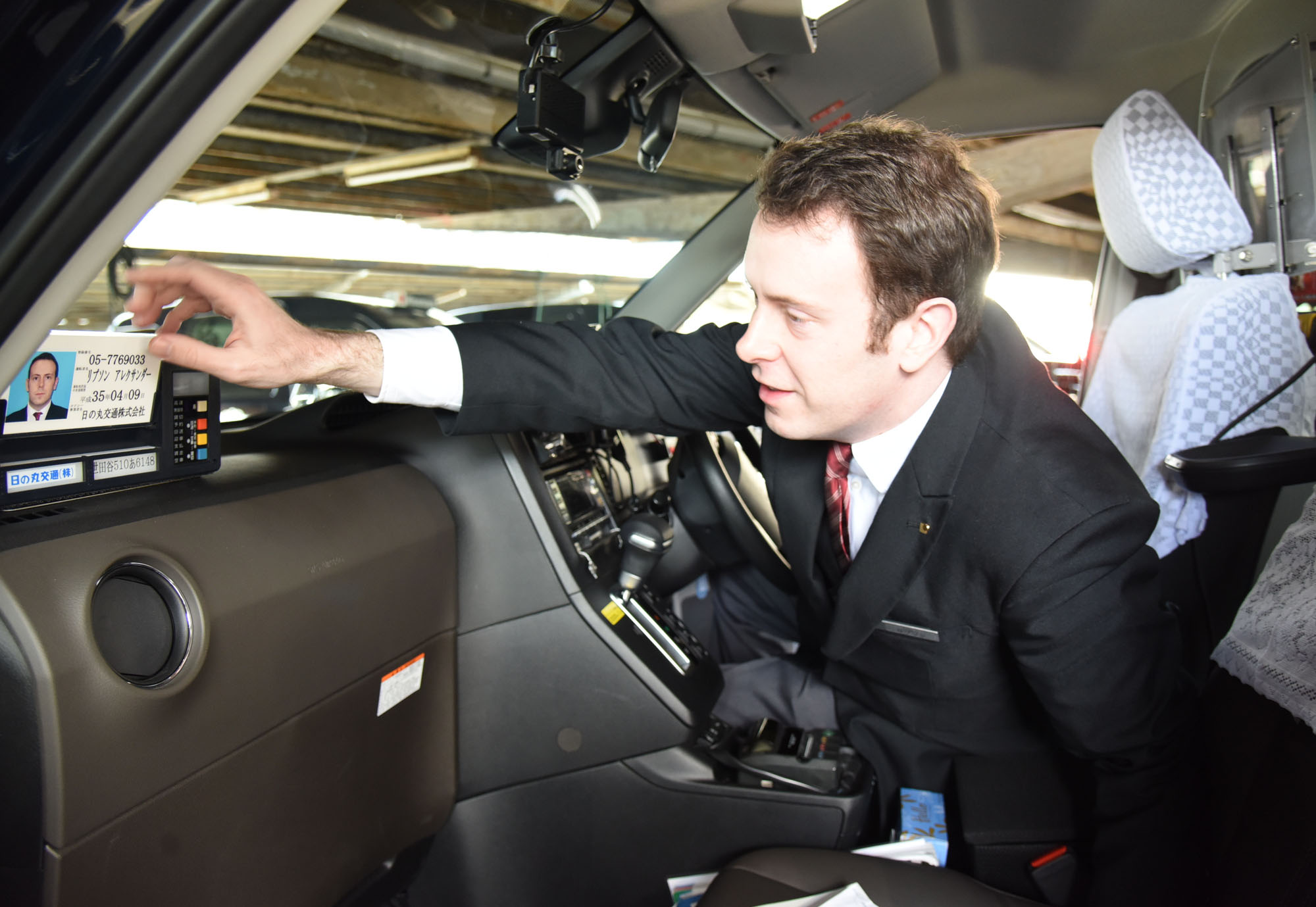Taxi driver Alex Lipson of Hinomaru Kotsu Co. starts his shift. 