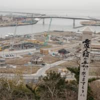 Heavy machinery dots the coastline of Ishinomaki, Miyagi Prefecture, on Feb. 19. The area is still rebuilding from the extensive damage caused by the Great East Japan Earthquake and ensuing tsunami on March 11, 2011. | MAGDALENA OSUMI