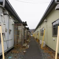 Temporary housing units stand in Ishinomaki, Miyagi Prefecture, on Feb. 19. Some evacuees from the March 2011 quake and tsunami are unable to move to more permanent units due to financial and other concerns. | MAGDALENA OSUMI