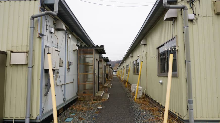 Temporary housing units stand in Ishinomaki, Miyagi Prefecture, on Feb. 19. Some evacuees from the March 2011 quake and tsunami are unable to move to more permanent units due to financial and other concerns.