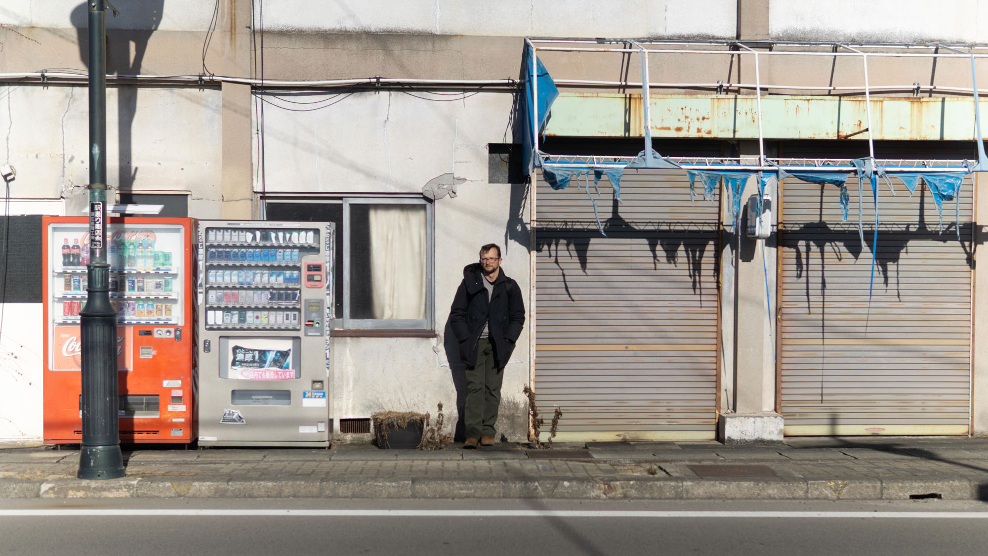 Emil Truszkowski stands on a street in the town of Namie, Fukushima Prefecture, where the evacuation order was partially lifted in 2017, on Jan. 17. | COURTESY OF EMIL TRUSZKOWSKI