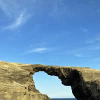 Sea, stone and sky: A rock arch on the rugged coast of Jogashima island, Kanagawa Prefecture. | OSCAR BOYD