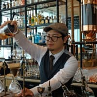 Coffee and cocktails: A bartender filters coffee at the Arriviamo bar to use in a drink. | CLAIRE WILLIAMSON