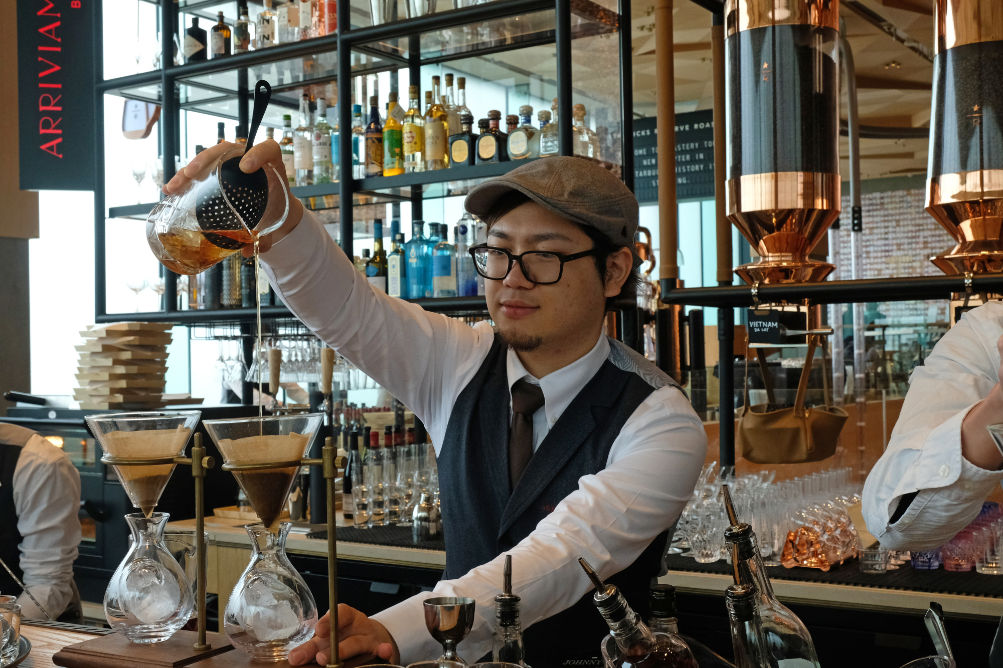 Coffee and cocktails: A bartender filters coffee at the Arriviamo bar to use in a drink.