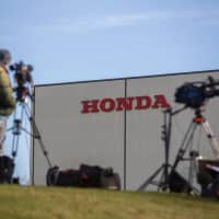 Media gather outside the Honda Motor Co. auto plant in Swindon, England, on Feb. 19, after Honda announced that it would be closing the factory. | BLOOMBERG