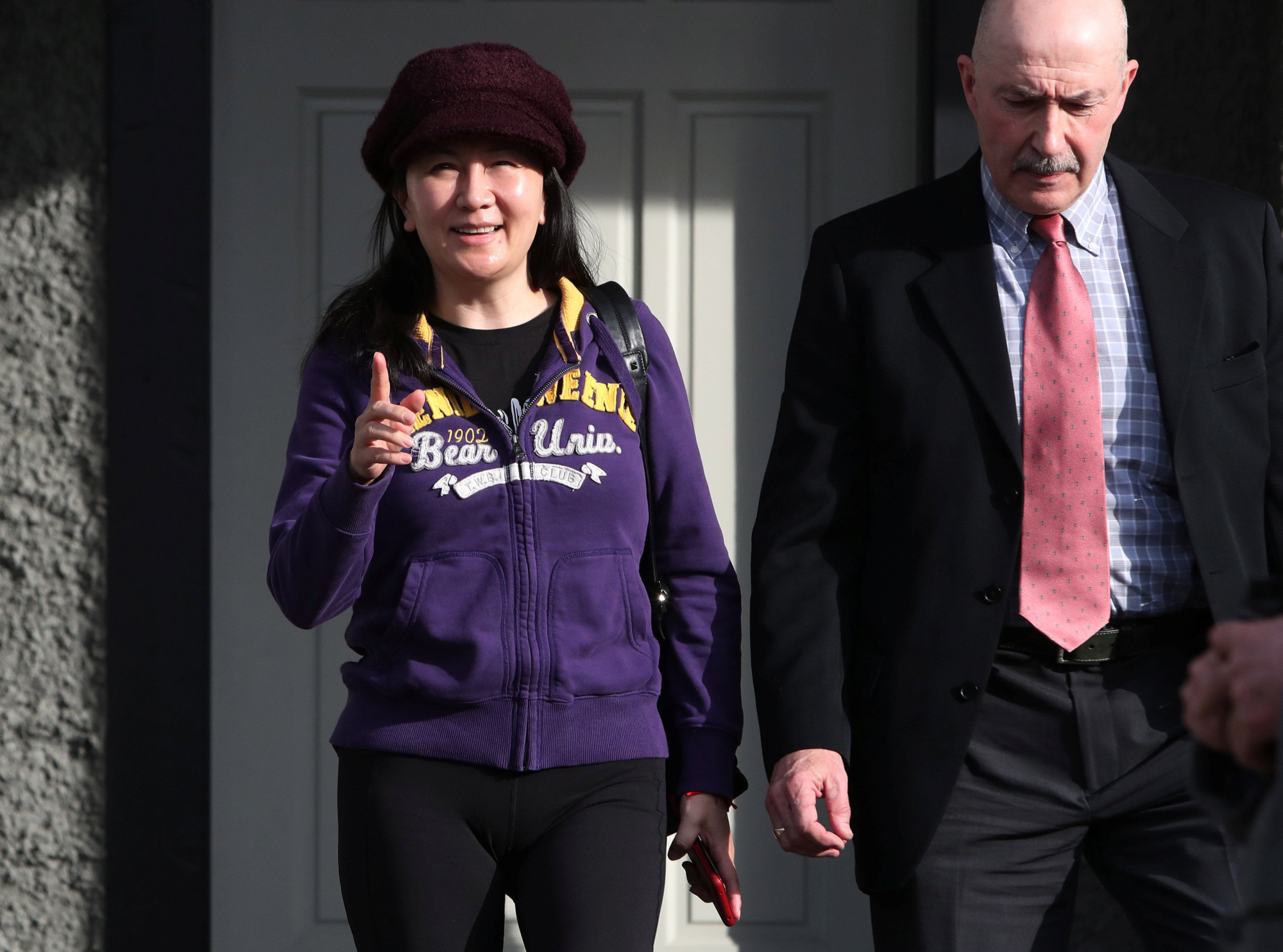 Huawei CFO Meng Wanzhou, under house arrest, is shown leaving her home in Vancouver, Canada, on March 6. | REUTERS