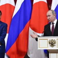 Prime Minister Shinzo Abe and Russian President Vladimir Putin hold a joint news conference in Moscow on Jan. 20 following talks that focused on the territorial dispute. | AP