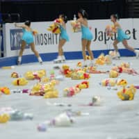 Winnie the Pooh toys can be seen on the ice following Yuzuru Hanyu\'s performance on Thursday. | DAN ORLOWITZ